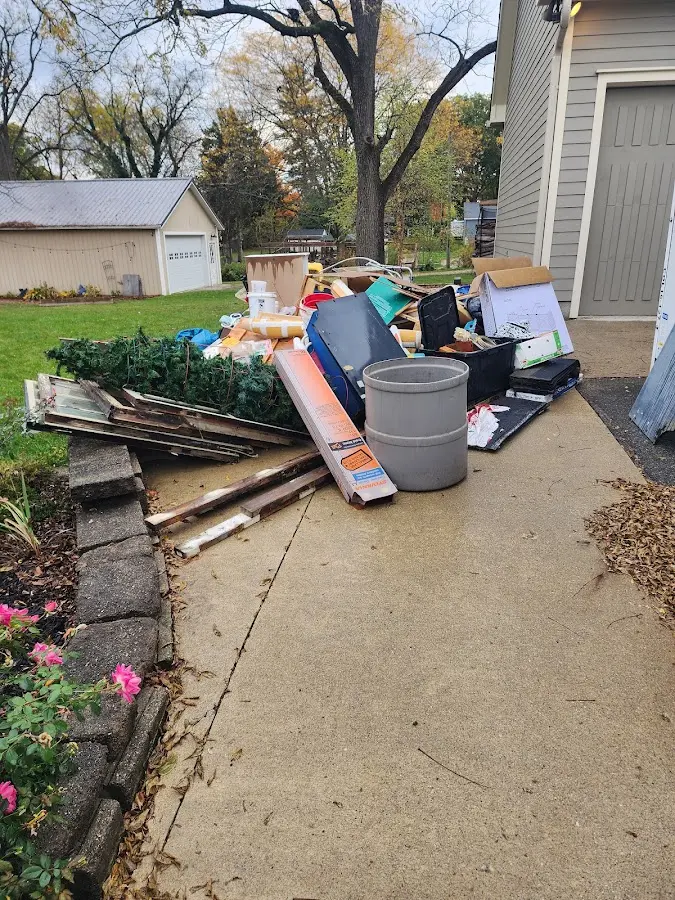 Dumpster being loaded with debris for Estate Cleanout Dumpster Rental in Philomath